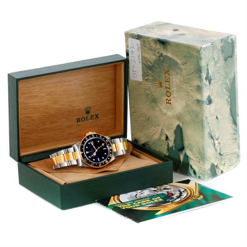 This image displays a Rolex GMT-Master 16713 Men's Stainless Steel Black Dial 16713 Men's Stainless Steel Black Dial watch in its open box, with packaging and manuals visible.