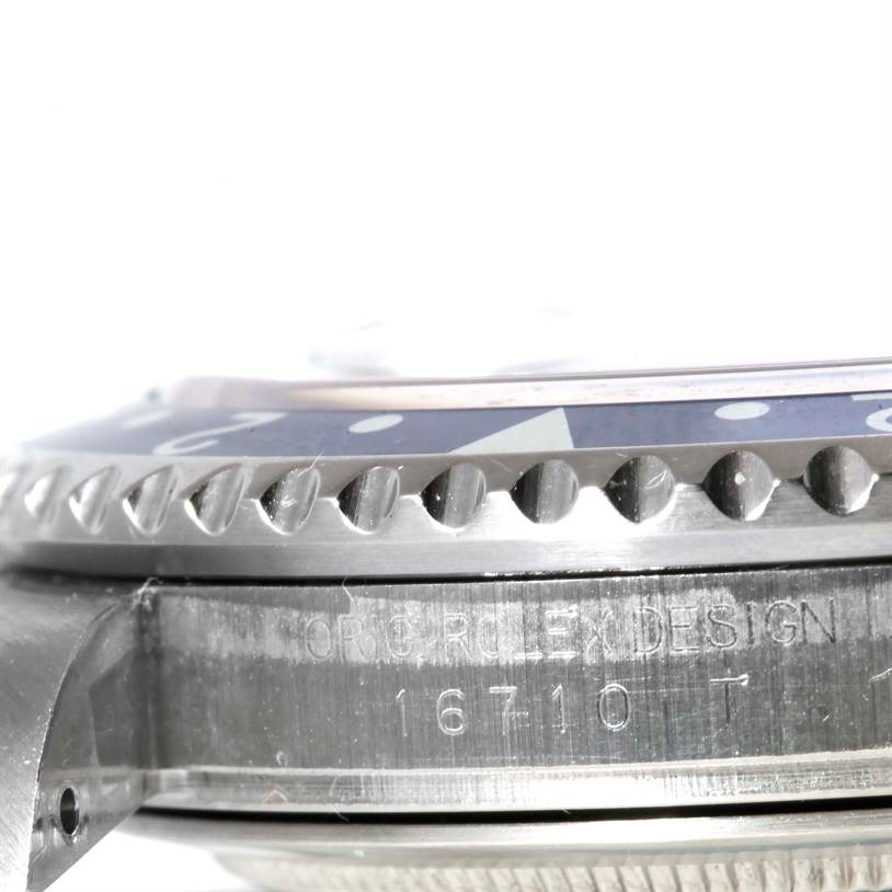 This close-up image shows the side view of the bezel and serial number of a Rolex GMT-Master 16710 Men's Stainless Steel Black Dial 16710 Men's Stainless Steel Black Dial watch.