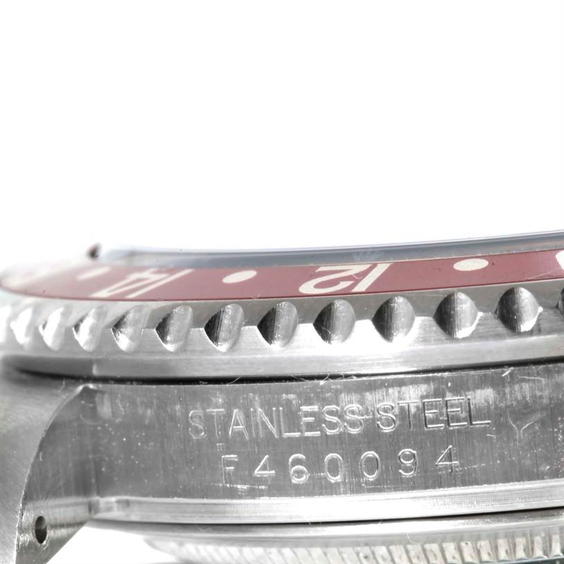 This image shows a close-up of the side and bezel of a Rolex GMT-Master 16710 Men's Stainless Steel Black Dial 16710 Men's Stainless Steel Black Dial watch, highlighting its stainless-steel case and serial number.