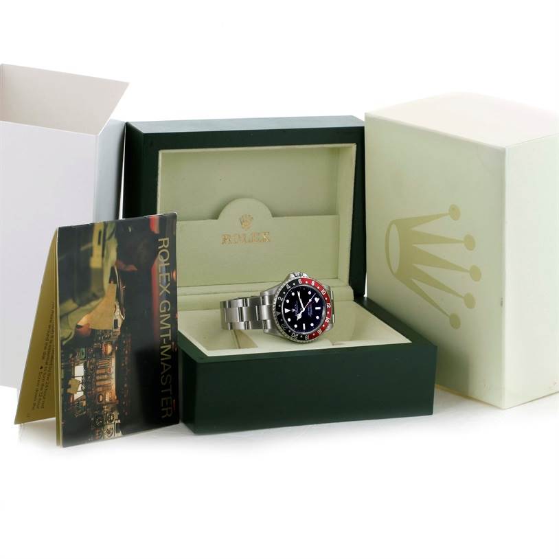 The image shows a Rolex GMT-Master 16710 Men's Stainless Steel Black Dial 16710 Men's Stainless Steel Black Dial watch displayed at an angle within an open green presentation box, alongside the packaging and booklet.