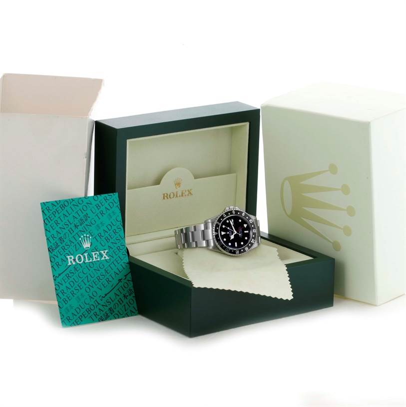 The Rolex GMT-Master 16710 Men's Stainless Steel Black Dial 16710 Men's Stainless Steel Black Dial watch is displayed inside an open green Rolex box along with a green manual and outer packaging.