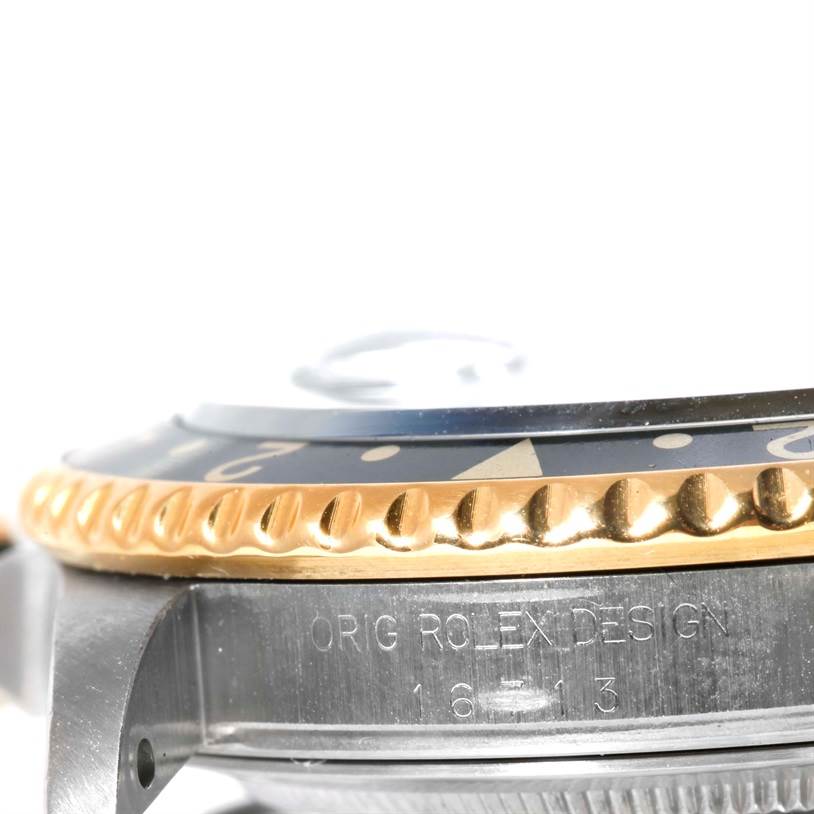 The image shows a close-up side angle of the bezel and case of a Rolex GMT-Master 16713 Men
s Stainless Steel Black Dial 16713 Men
s Stainless Steel Black Dial watch.