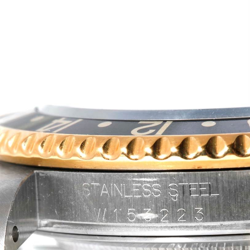 The image shows a close-up side angle of the bezel and part of the case of a Rolex GMT-Master 16713 Men
s Stainless Steel Black Dial 16713 Men
s Stainless Steel Black Dial watch.