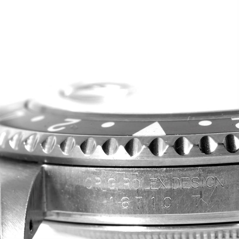 The image shows a side view of the bezel and case of a Rolex GMT-Master 16710 Men's Stainless Steel Black Dial 16710 Men's Stainless Steel Black Dial watch, highlighting details and engravings on the side.