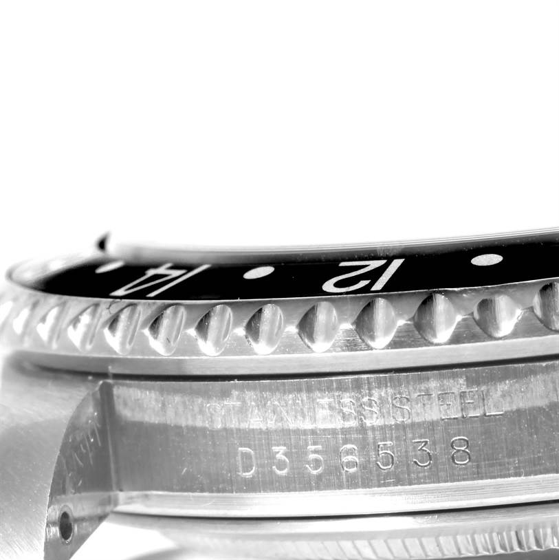 This is a close-up view of the bezel, case, and serial number of a Rolex GMT-Master 16710 Men
s Stainless Steel Black Dial 16710 Men
s Stainless Steel Black Dial watch.