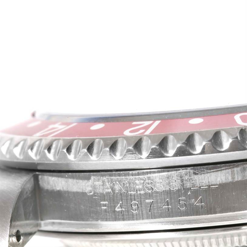 The image shows a close-up of the side view of a Rolex GMT-Master 16710 Men's Stainless Steel Black Dial 16710 Men's Stainless Steel Black Dial watch, highlighting the bezel and stainless steel engraving.