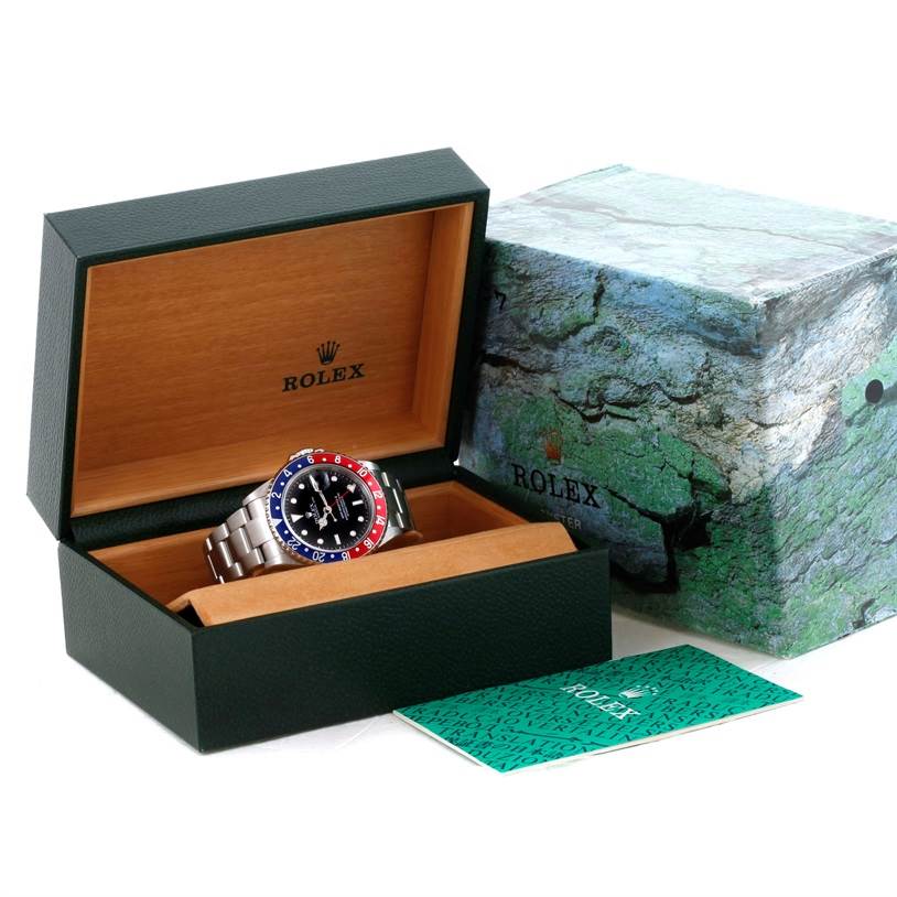 The image shows a Rolex GMT-Master 16710 Men's Stainless Steel Black Dial 16710 Men's Stainless Steel Black Dial watch in its open box, with the outer box and warranty card visible nearby.