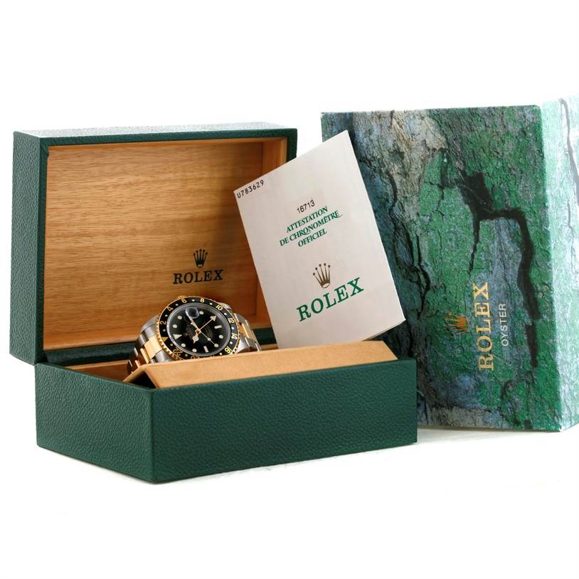 The image shows a Rolex GMT-Master 16713 Men's Stainless Steel Black Dial 16713 Men's Stainless Steel Black Dial watch in its open box alongside its official certificate.