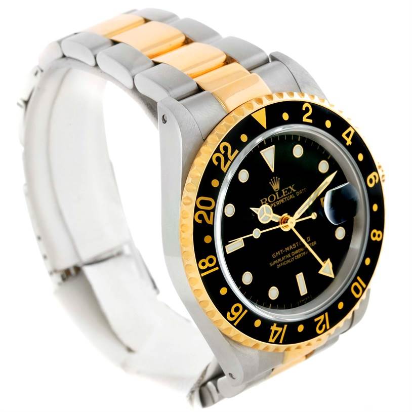 The Rolex GMT-Master 16713 Men's Stainless Steel Black Dial 16713 Men's Stainless Steel Black Dial watch is shown from an angle highlighting its dial, bezel, case, and two-tone bracelet.