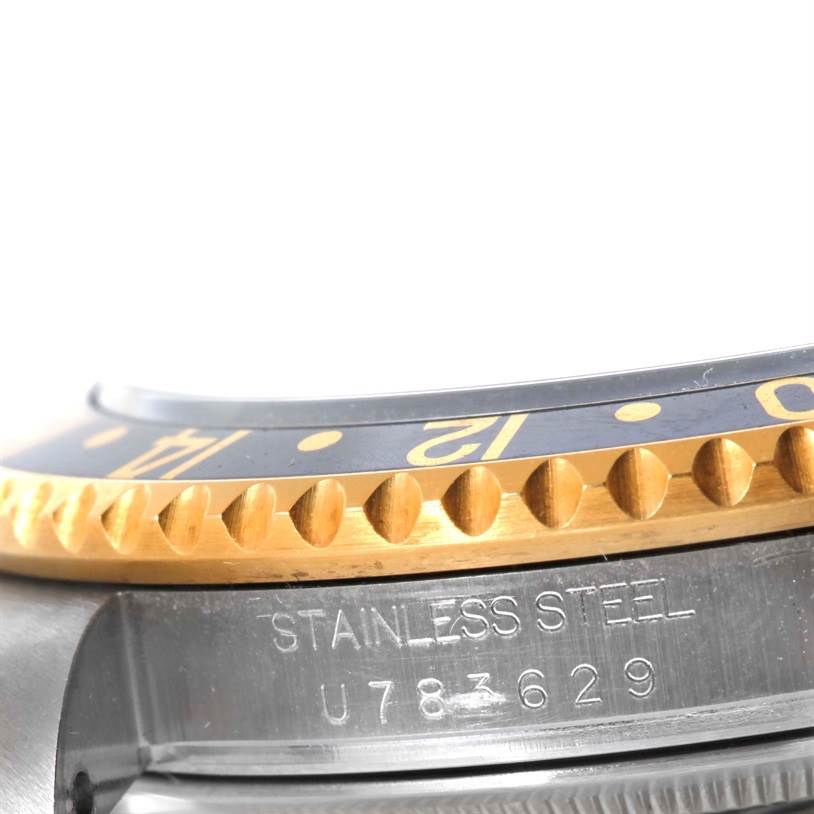 The close-up shows the bezel and side details of a Rolex GMT-Master 16713 Men's Stainless Steel Black Dial 16713 Men's Stainless Steel Black Dial, highlighting the stainless steel and gold markings.