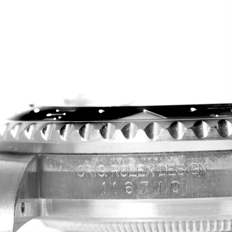 This close-up angle shows the case side and bezel edge of the Rolex GMT-Master 116710 Men's Stainless Steel Black Dial 116710 Men's Stainless Steel Black Dial model, highlighting the inscriptions and design.
