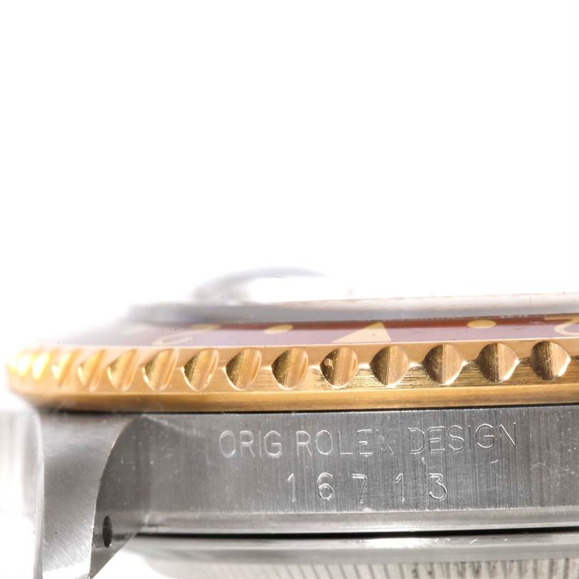 This image shows a close-up side view of a Rolex GMT-Master 16713 Men's Stainless Steel Brown Dial 16713 Men's Stainless Steel Brown Dial, focusing on the bezel and part of the watch case with the engraved model number "16713".