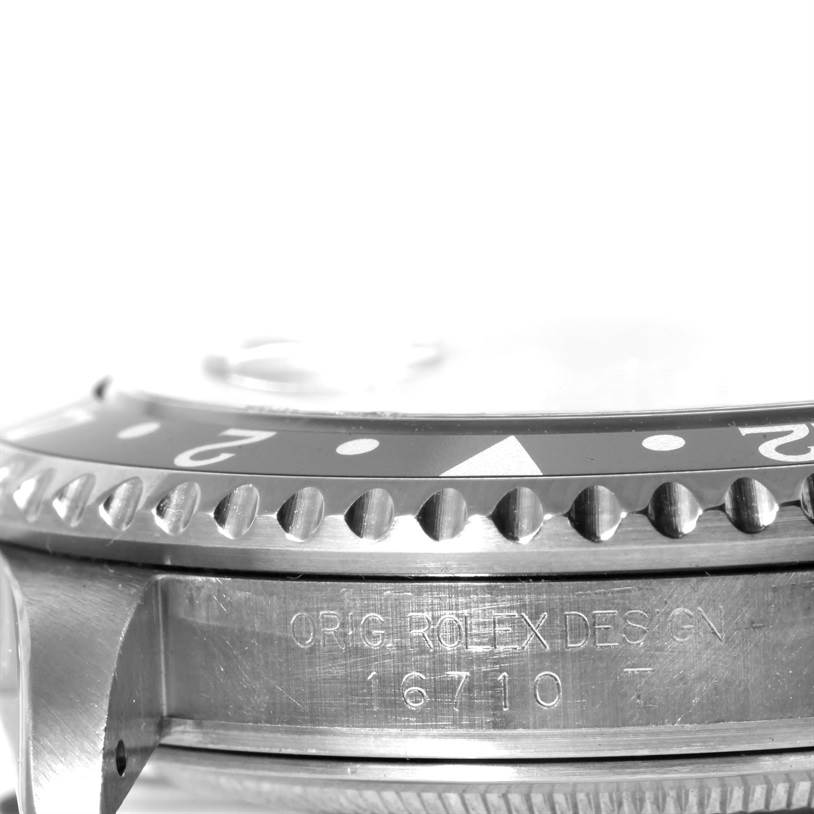 The image shows a close-up side view of the bezel and case of a Rolex GMT-Master 16710 Men
s Stainless Steel Black Dial 16710 Men
s Stainless Steel Black Dial model 16710 watch.