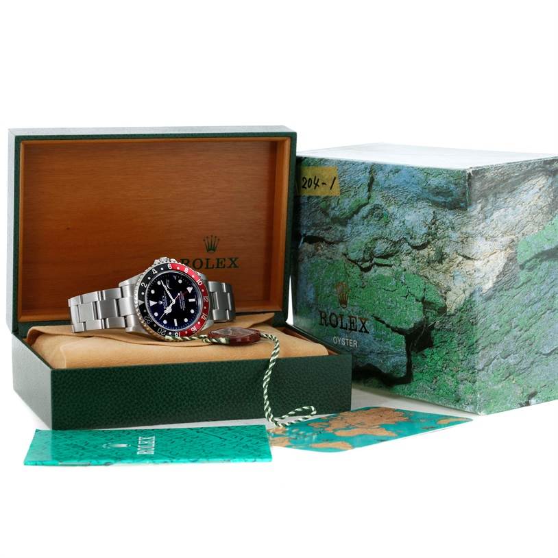The Rolex GMT-Master 16710 Men
s Stainless Steel Black Dial 16710 Men
s Stainless Steel Black Dial watch is shown in its open box, with its bracelet displayed, alongside the outer box and accompanying accessories.