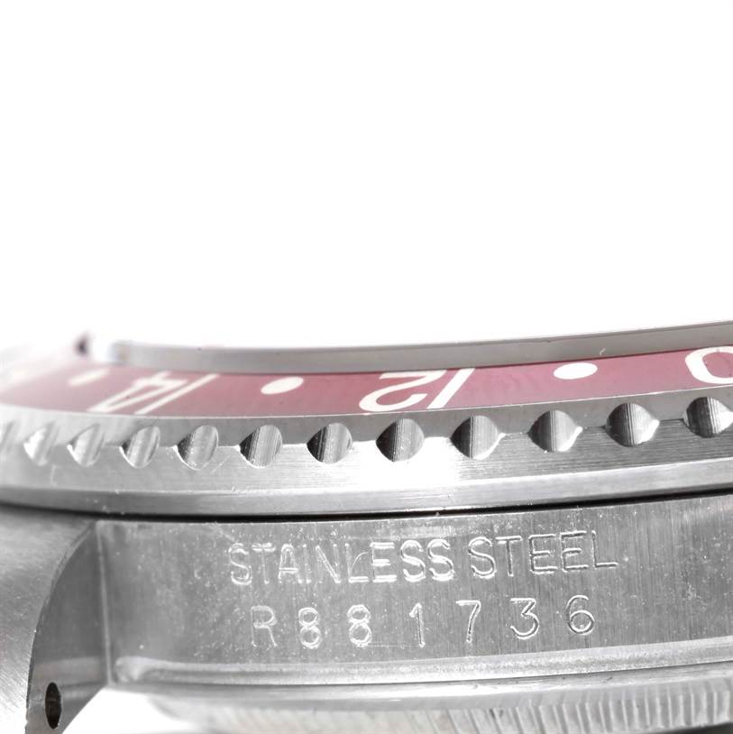 The image shows a close-up of the stainless steel bezel and part of the casing of a Rolex GMT-Master 16700 Men's Stainless Steel Black Dial 16700 Men's Stainless Steel Black Dial watch.