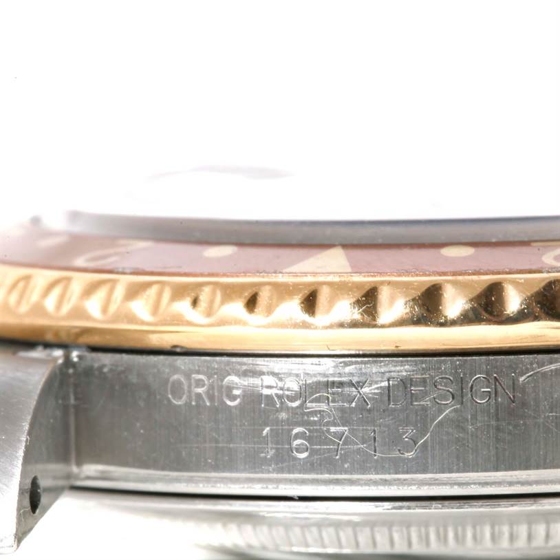 This image shows the side angle of a Rolex GMT-Master 16713 Men's Stainless Steel Brown Dial 16713 Men's Stainless Steel Brown Dial watch, highlighting the bezel, watch case, and model engraving.