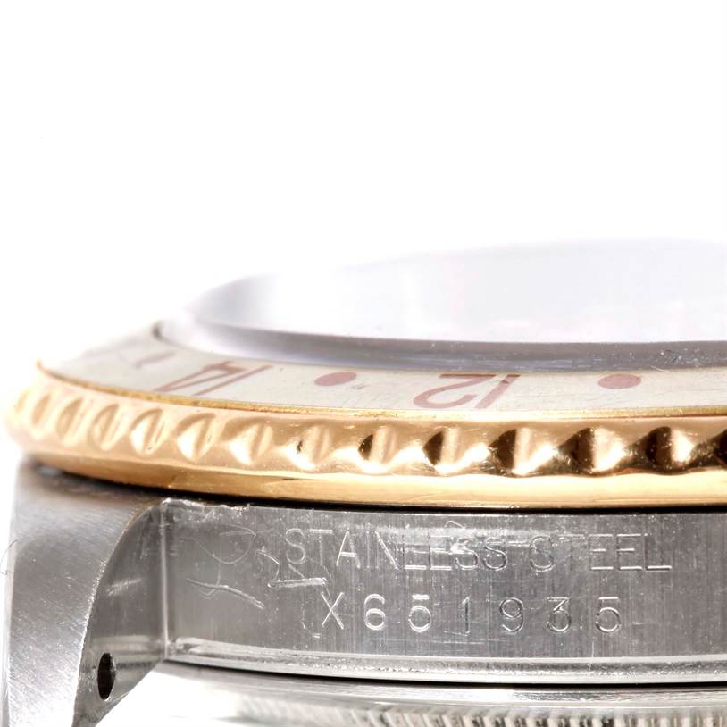 This image shows a close-up side view of the bezel and case of a Rolex GMT-Master 16713 Men's Stainless Steel Brown Dial 16713 Men's Stainless Steel Brown Dial watch, highlighting the "Stainless Steel" engraving.