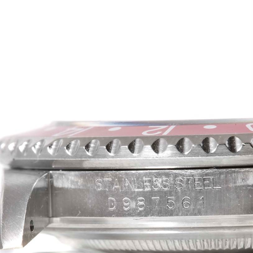 The image shows a side angle of the Rolex GMT-Master 16710 Men's Stainless Steel Black Dial 16710 Men's Stainless Steel Black Dial watch, highlighting the stainless steel case and the model's serial number.