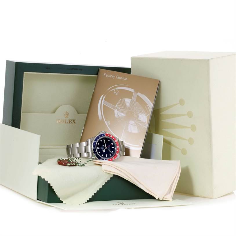 This image shows the Rolex GMT-Master 16710 Men's Stainless Steel Black Dial 16710 Men's Stainless Steel Black Dial watch at an angle that highlights the dial and bezel, along with its box, papers, and accessories.