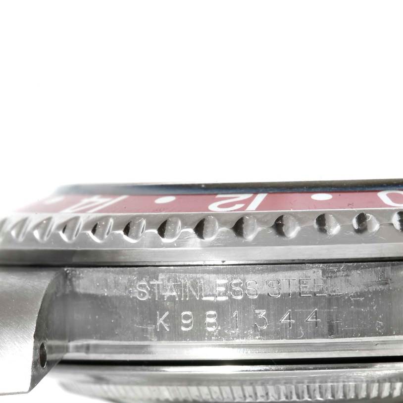 This image shows a close-up side view of the bezel and case with the serial number of a Rolex GMT-Master 16710 Men's Stainless Steel Black Dial 16710 Men's Stainless Steel Black Dial watch.