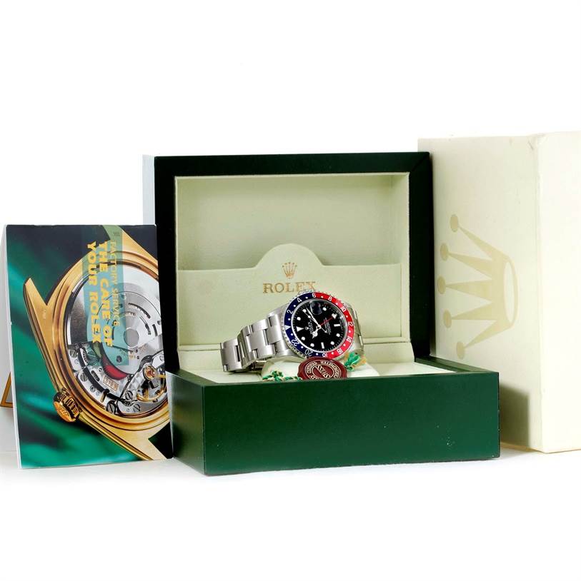 The Rolex GMT-Master 16710 Men's Stainless Steel Black Dial 16710 Men's Stainless Steel Black Dial watch is displayed inside its open box, along with accompanying booklets.