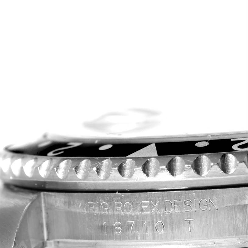 This image shows a close-up of the bezel, crown guard, case, and model number engraving of a Rolex GMT-Master 16710 Men's Stainless Steel Black Dial 16710 Men's Stainless Steel Black Dial watch.