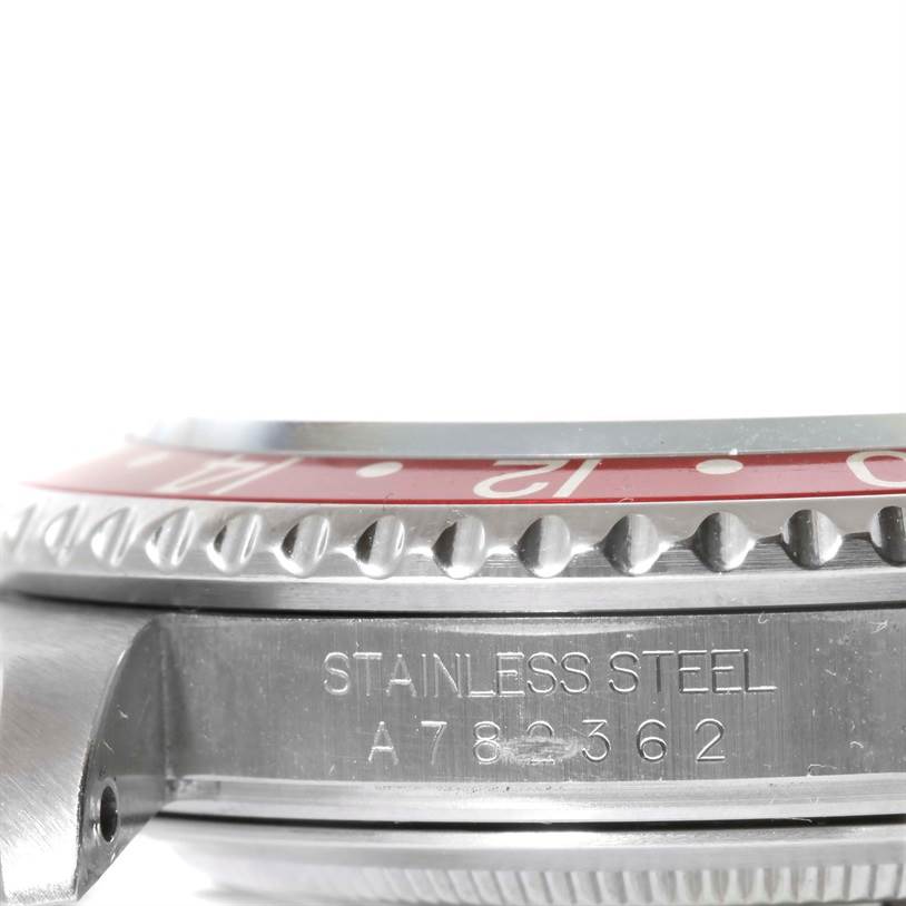 The side view of the Rolex GMT-Master 16710 Men's Stainless Steel Black Dial 16710 Men's Stainless Steel Black Dial watch shows the stainless steel case and bezel with its serial number.