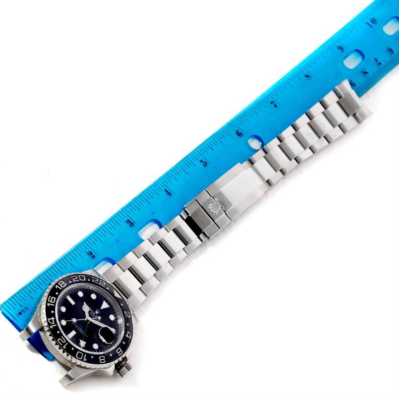 The image shows a top view of the Rolex GMT-Master 116710 Men
s Stainless Steel Black Dial 116710 Men
s Stainless Steel Black Dial watch, highlighting the face, bezel, and metal bracelet with a ruler for scale.