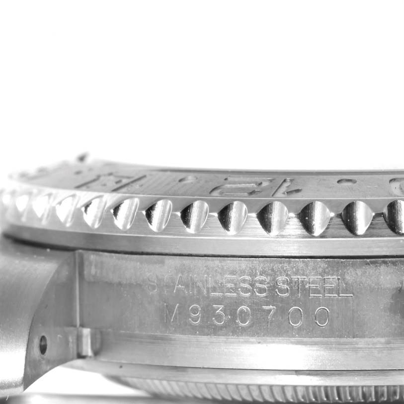 This close-up image of a Rolex GMT-Master 116710 Men
s Stainless Steel Black Dial 116710 Men
s Stainless Steel Black Dial shows the bezel and part of the stainless steel case with etched markings.