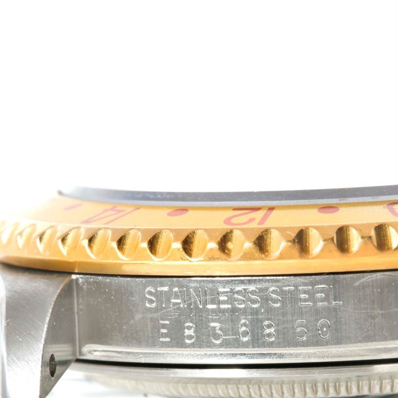 The image shows a close-up of the side view of the GMT-Master Rolex watch, highlighting the stainless steel casing and the gold bezel.