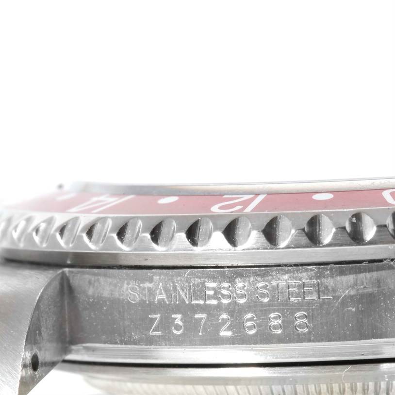 The image shows a close-up side view of the bezel and case of a Rolex GMT-Master 16710 Men's Stainless Steel Black Dial 16710 Men's Stainless Steel Black Dial watch with visible serial and material markings.