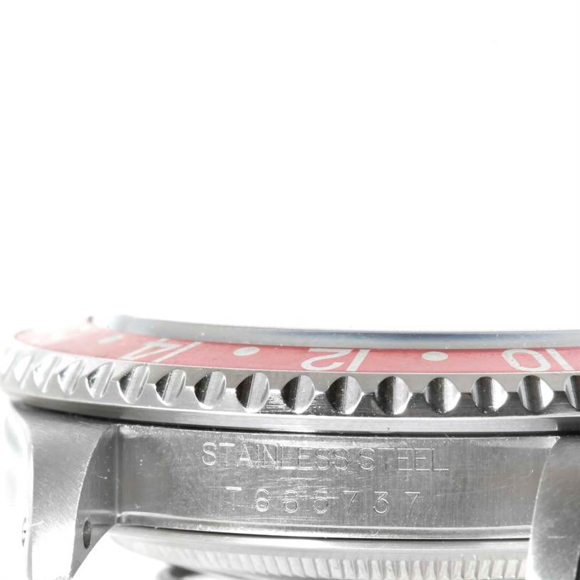 This is a close-up side angle of the bezel and case of a Rolex GMT-Master 16700 Men's Stainless Steel Black Dial 16700 Men's Stainless Steel Black Dial watch, showing the stainless steel material and serial number.