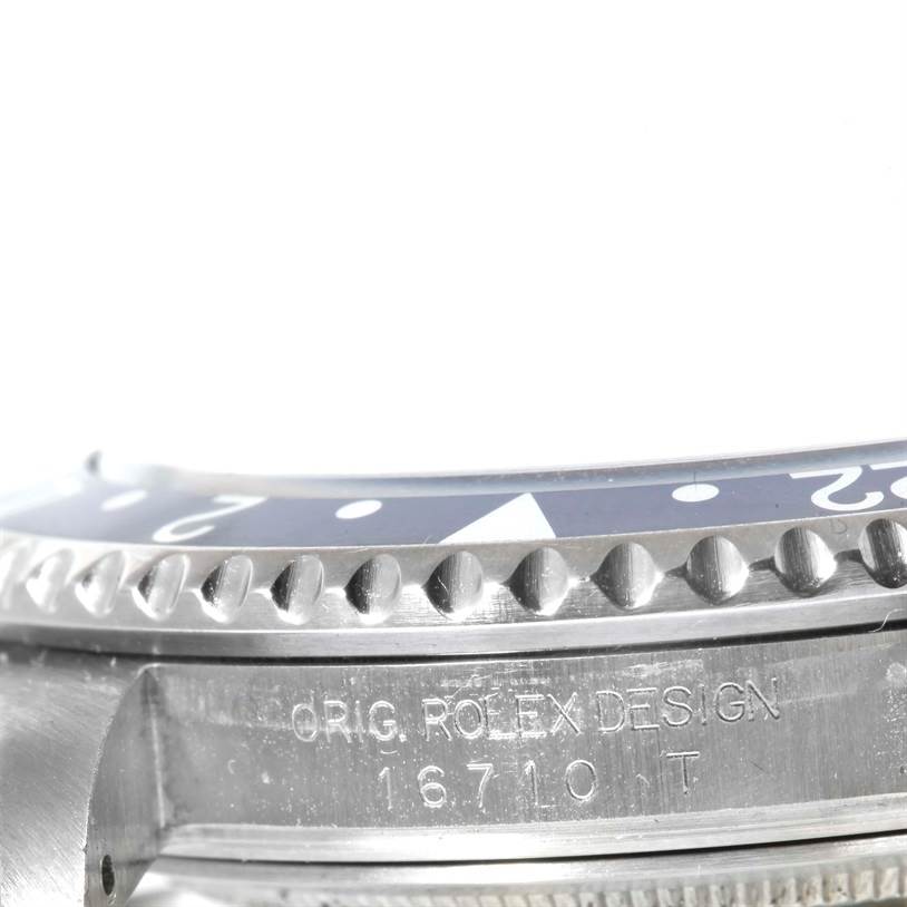 The image shows a close-up view of the bezel and case of a Rolex GMT-Master 16710 Men's Stainless Steel Black Dial 16710 Men's Stainless Steel Black Dial watch, including the model number 16710T.