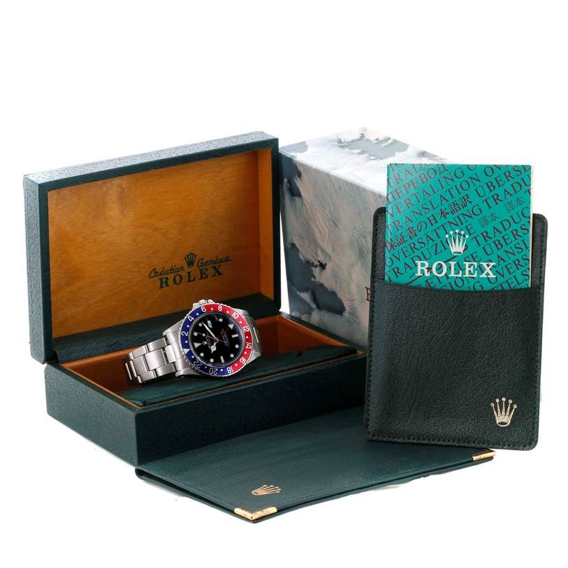 The Rolex GMT-Master 16750 Men's Stainless Steel Black Dial 16750 Men's Stainless Steel Black Dial watch is displayed at an angle in its open box, accompanied by an outer box and a document holder.