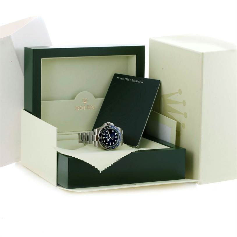 The image shows the side view of a Rolex GMT-Master 116710 Men's Stainless Steel Black Dial 116710 Men's Stainless Steel Black Dial watch, along with its green box and manual.