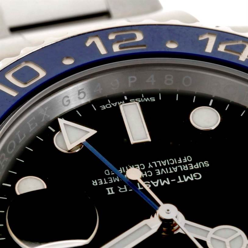 This close-up image of a Rolex GMT-Master 116710 Men's Stainless Steel Black Dial 116710 Men's Stainless Steel Black Dial II watch shows part of the dial, bezel, and a few hands.