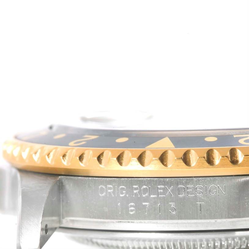 This image shows a side view of a Rolex GMT-Master 16713 Men's Stainless Steel Black Dial 16713 Men's Stainless Steel Black Dial watch model, highlighting the bezel and case with the model number engraved.