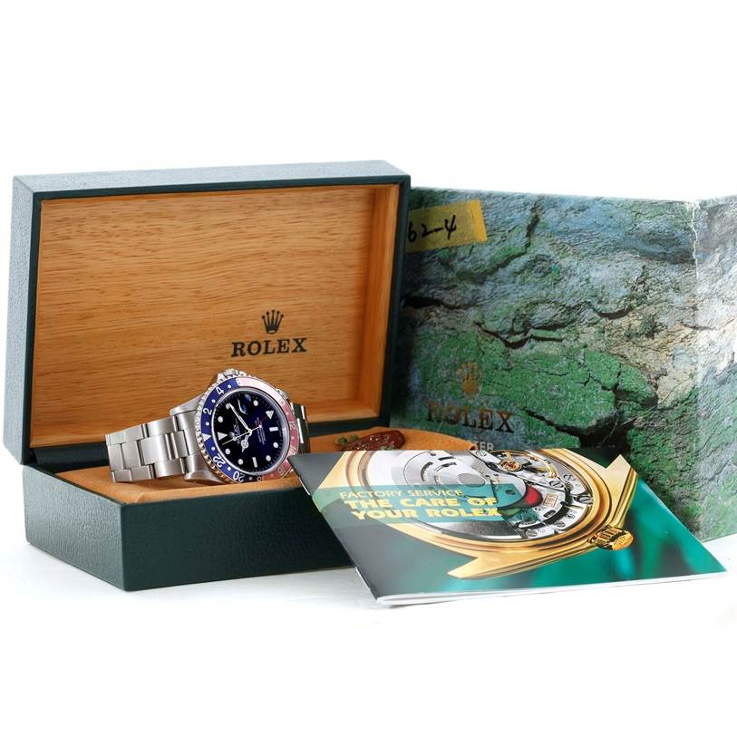 This image shows a Rolex GMT-Master 16700 Men's Stainless Steel Black Dial 16700 Men's Stainless Steel Black Dial watch at an angle inside its box, along with handbook and outer packaging.