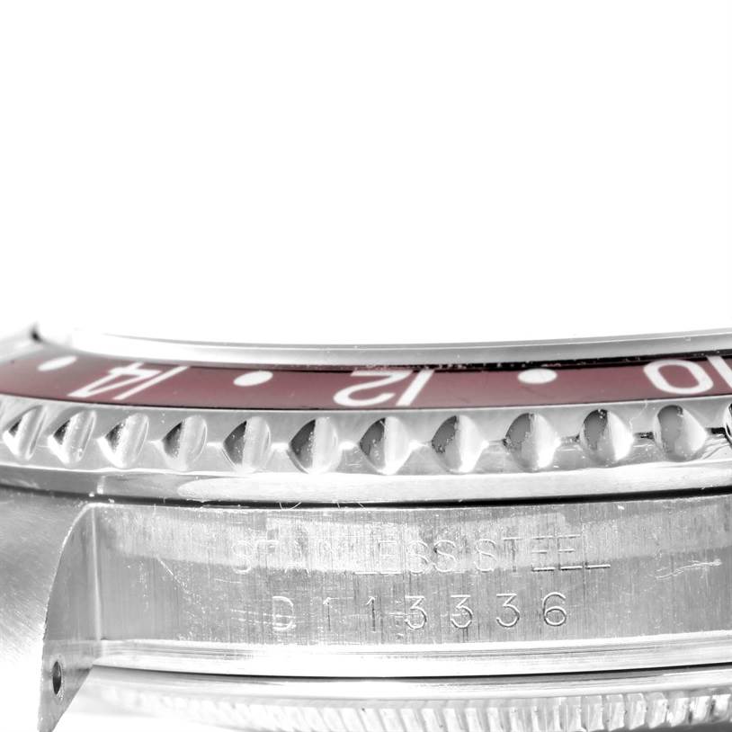 This close-up image of the Rolex GMT-Master 16710 Men's Stainless Steel Black Dial 16710 Men's Stainless Steel Black Dial shows the bezel and part of the case with engraved text.
