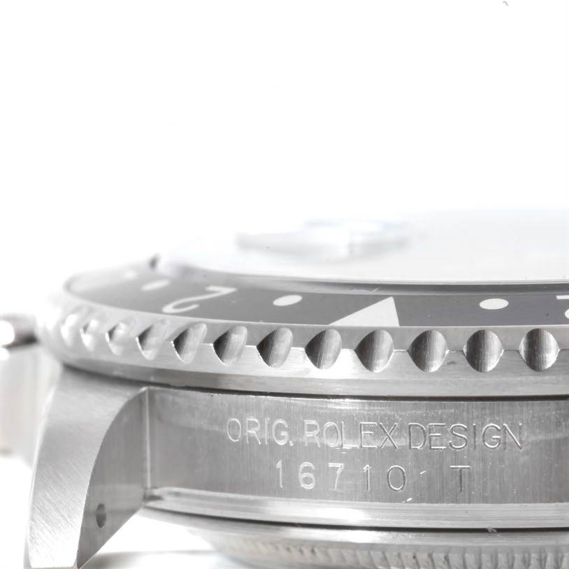 The image shows a side angle of the bezel and case of a Rolex GMT-Master 16710 Men's Stainless Steel Black Dial 16710 Men's Stainless Steel Black Dial model watch, focusing on the "ORIG. ROLEX DESIGN 16710 T" engraving.