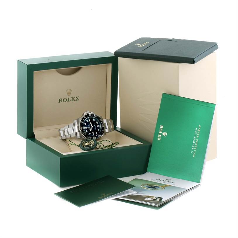 The image shows a Rolex GMT-Master 116710 Men's Stainless Steel Black Dial 116710 Men's Stainless Steel Black Dial watch in its open green box, with accompanying booklets and a tag.