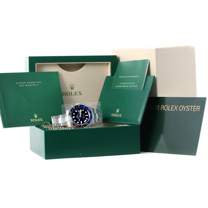 The image shows a Rolex GMT-Master 116710BLNR Men's Stainless Steel Black Dial 116710BLNR Men's Stainless Steel Black Dial watch with its green box, manuals, and accessories displayed from a front angle.