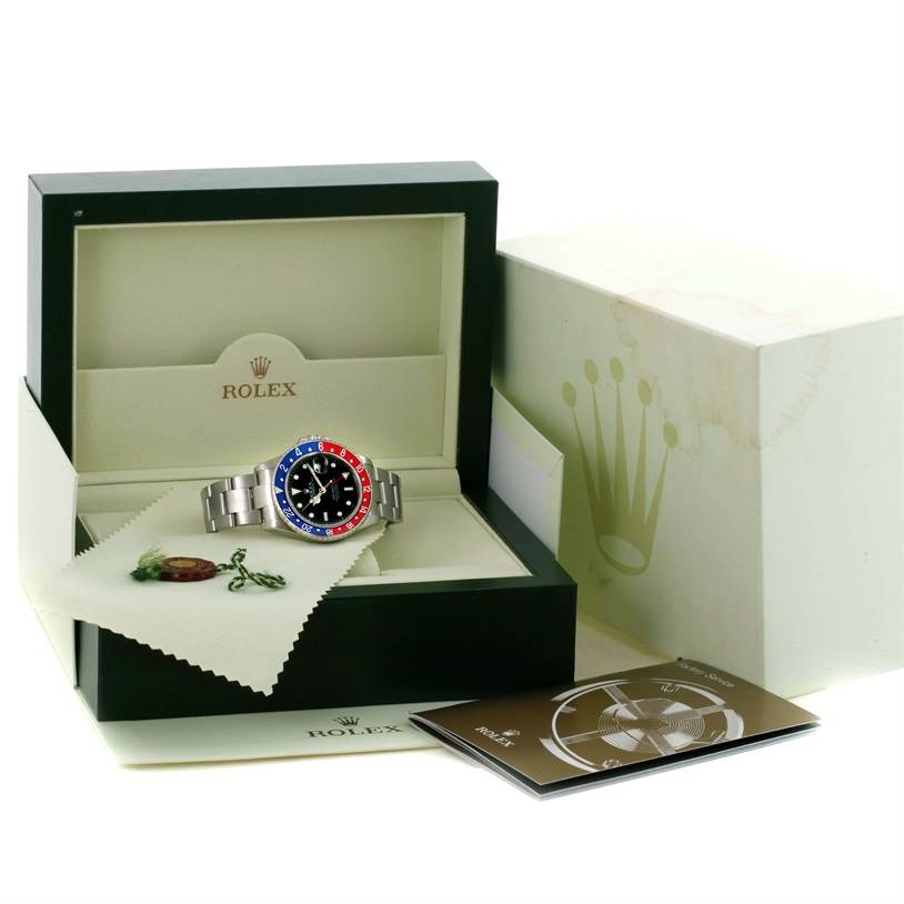 The Rolex GMT-Master 16710 Men's Stainless Steel Black Dial 16710 Men's Stainless Steel Black Dial watch is displayed front-facing in its open box with accompanying booklets.