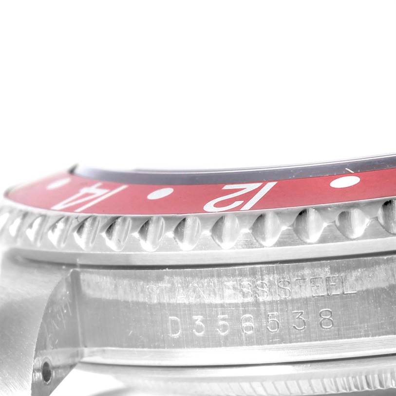 The image shows a close-up of the bezel and side case with engraving of the GMT-Master model by Rolex.