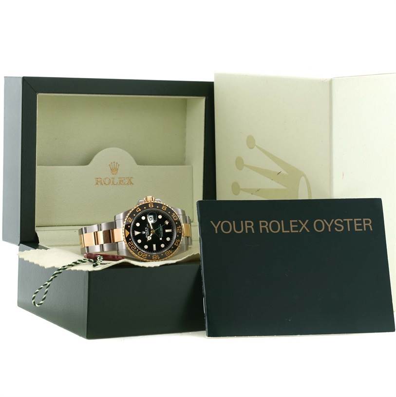 The Rolex GMT-Master 116713LN Men's Stainless Steel Black Dial 116713LN Men's Stainless Steel Black Dial watch is shown with its box and warranty card, angled slightly to the left.
