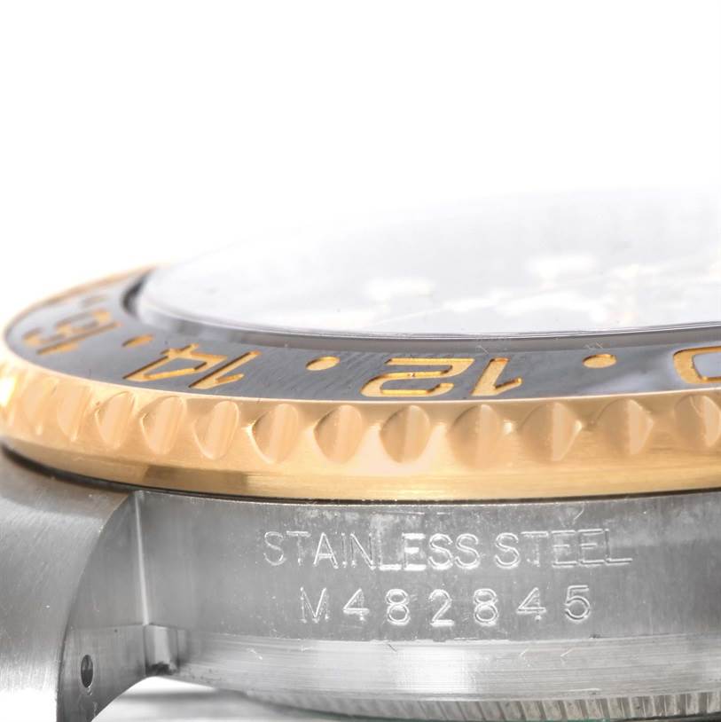 This close-up angle shows the side of the bezel, the crystal, and the engraved case of the Rolex GMT-Master 116713LN Men's Stainless Steel Black Dial 116713LN Men's Stainless Steel Black Dial watch.