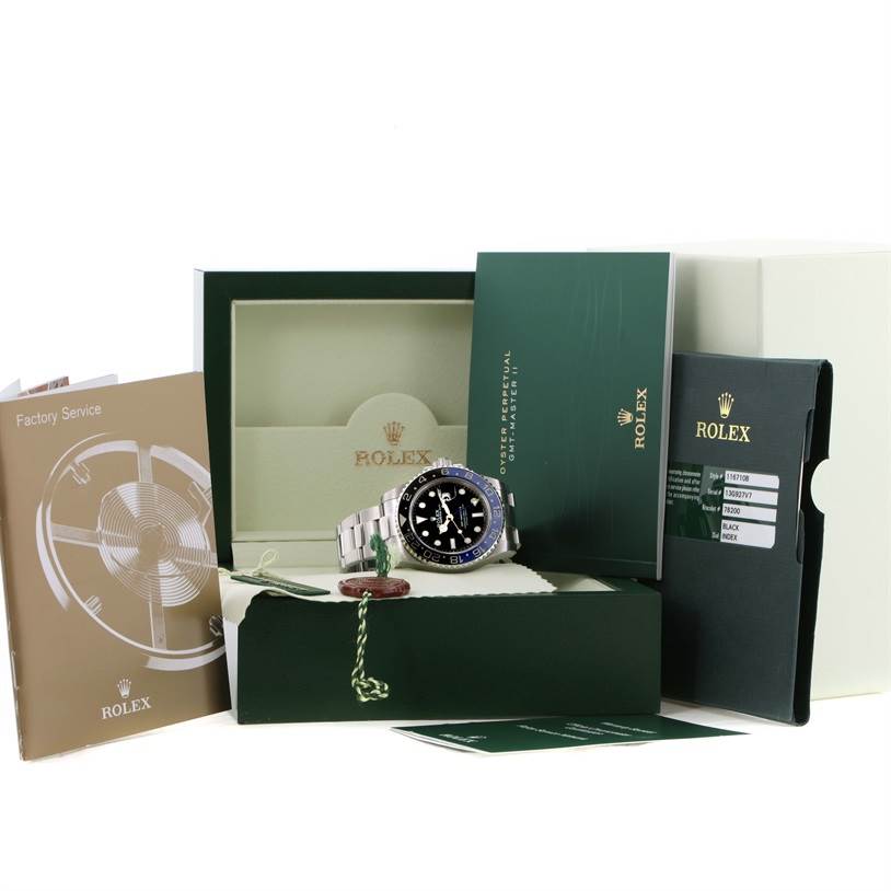 The Rolex GMT-Master 116710BLNR Men's Stainless Steel Black Dial 116710BLNR Men's Stainless Steel Black Dial watch is showcased with its box, manuals, and warranty card.
