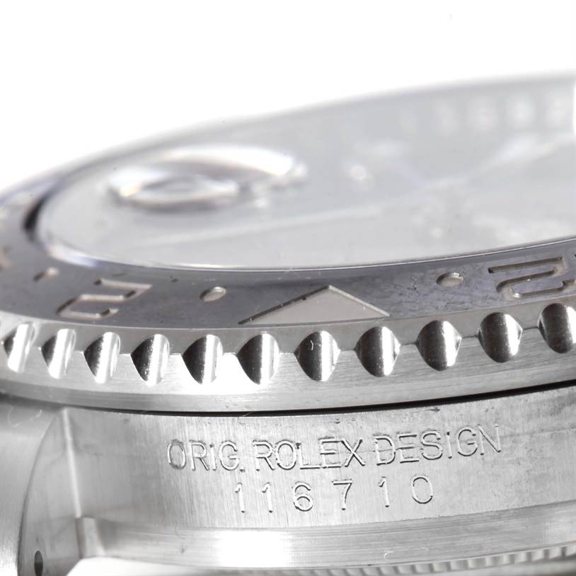 The image shows a close-up angle of a Rolex GMT-Master 116710BLNR Men's Stainless Steel Black Dial 116710BLNR Men's Stainless Steel Black Dial's bezel and case, featuring the model number engraved on the side.