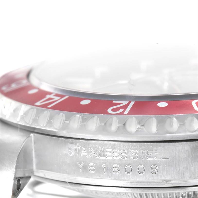 This close-up image of a Rolex GMT-Master 16710 Men's Stainless Steel Black Dial 16710 Men's Stainless Steel Black Dial watch shows the side of the case and part of the bezel.