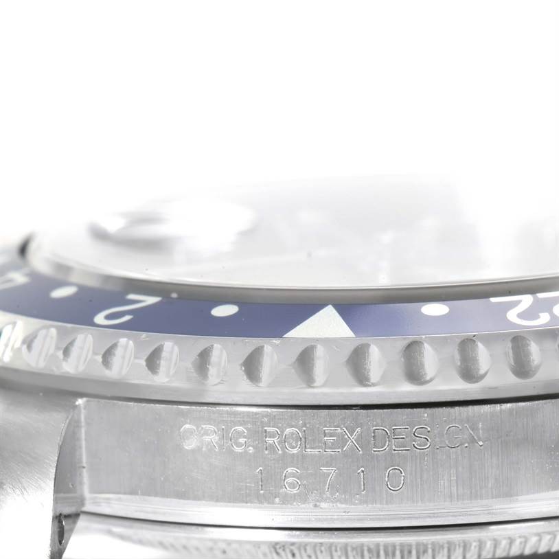 This close-up angle shows the bezel and part of the engraved case of the Rolex GMT-Master 16710 Men's Stainless Steel Black Dial 16710 Men's Stainless Steel Black Dial model.